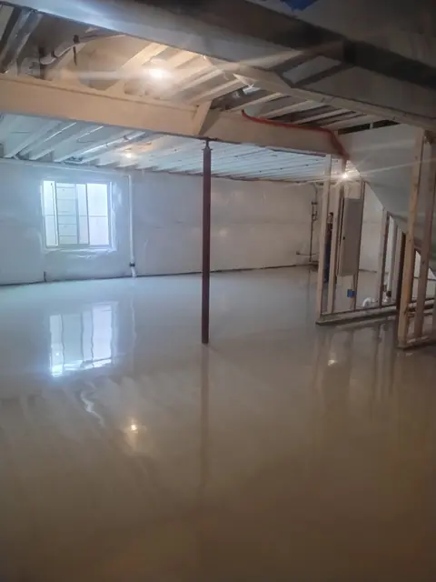 Glossy epoxy floor in a basement with support post