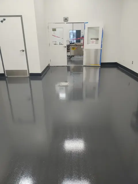 Dark gray high-gloss epoxy floor with floor drain