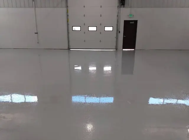 Glossy epoxy floor in a shop with overhead door