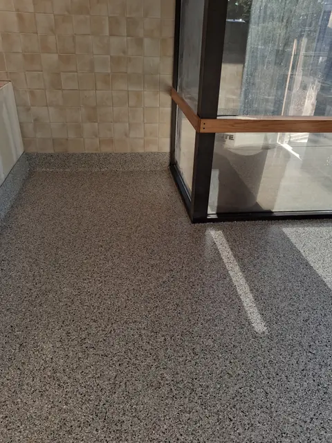 Quartz floor meeting a glass storefront wall