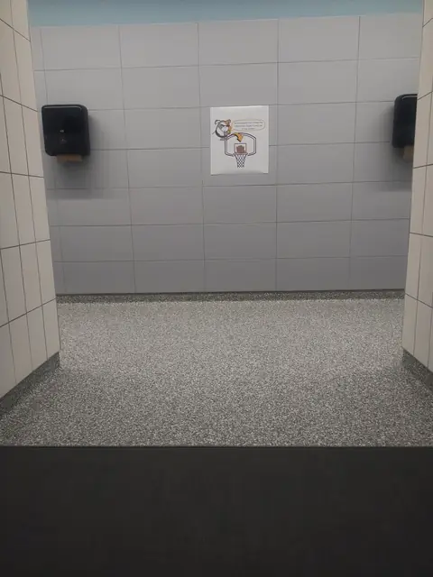 Quartz restroom floor with cove base at entry