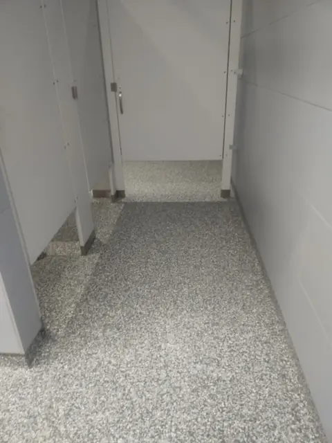 Quartz floor in a restroom stall corridor