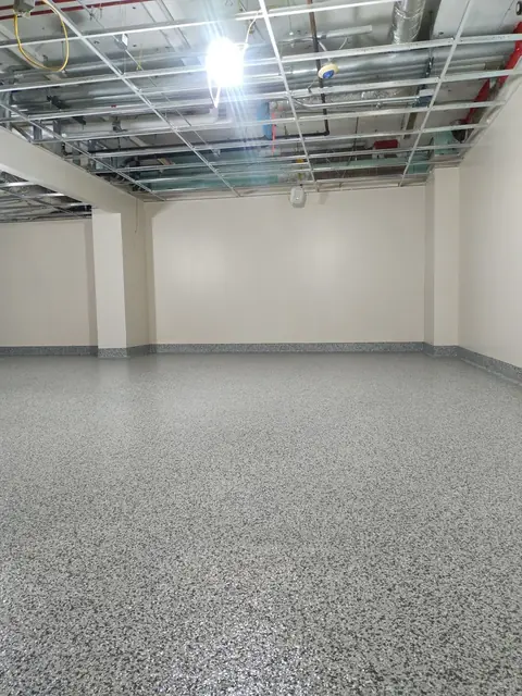 Quartz floor with cove base in a commercial room
